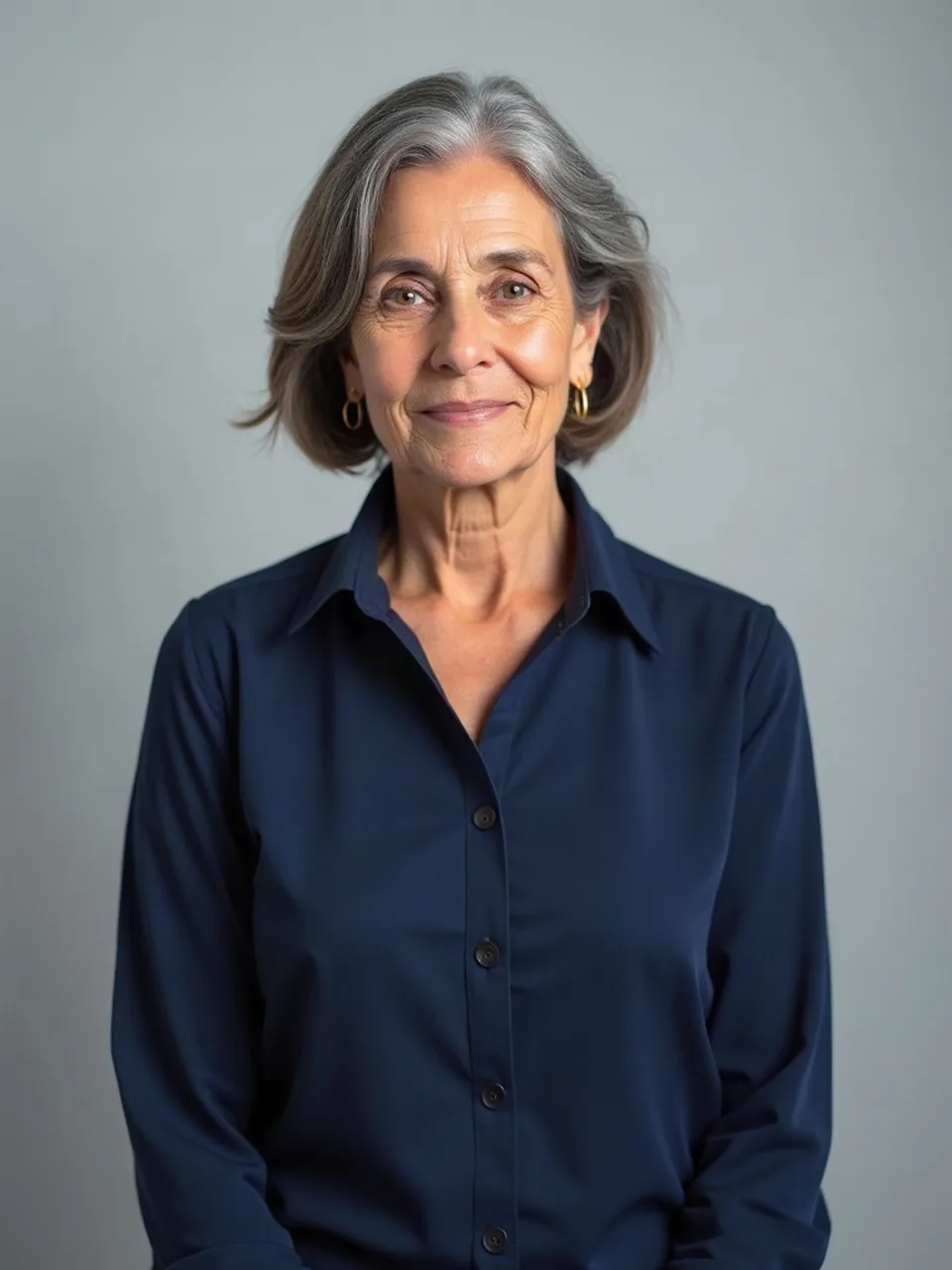 Before: a woman in her sixties standing in a navy blouse.